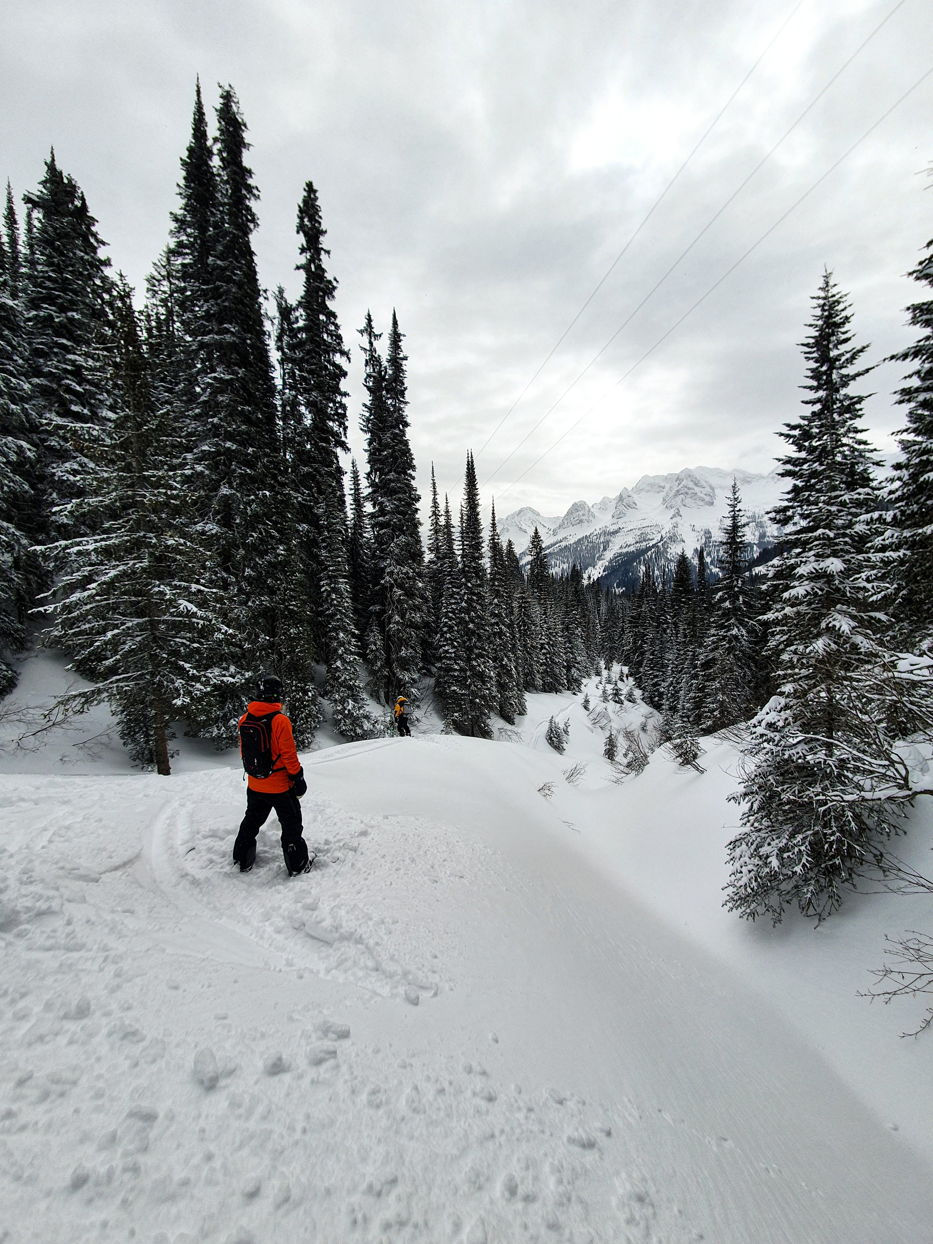 MAN STANDING ALONE ON A SNOWYHILL