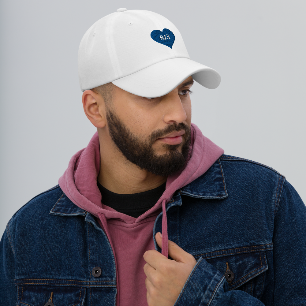 Man wearing white Tampa Bay Area Code Hat.