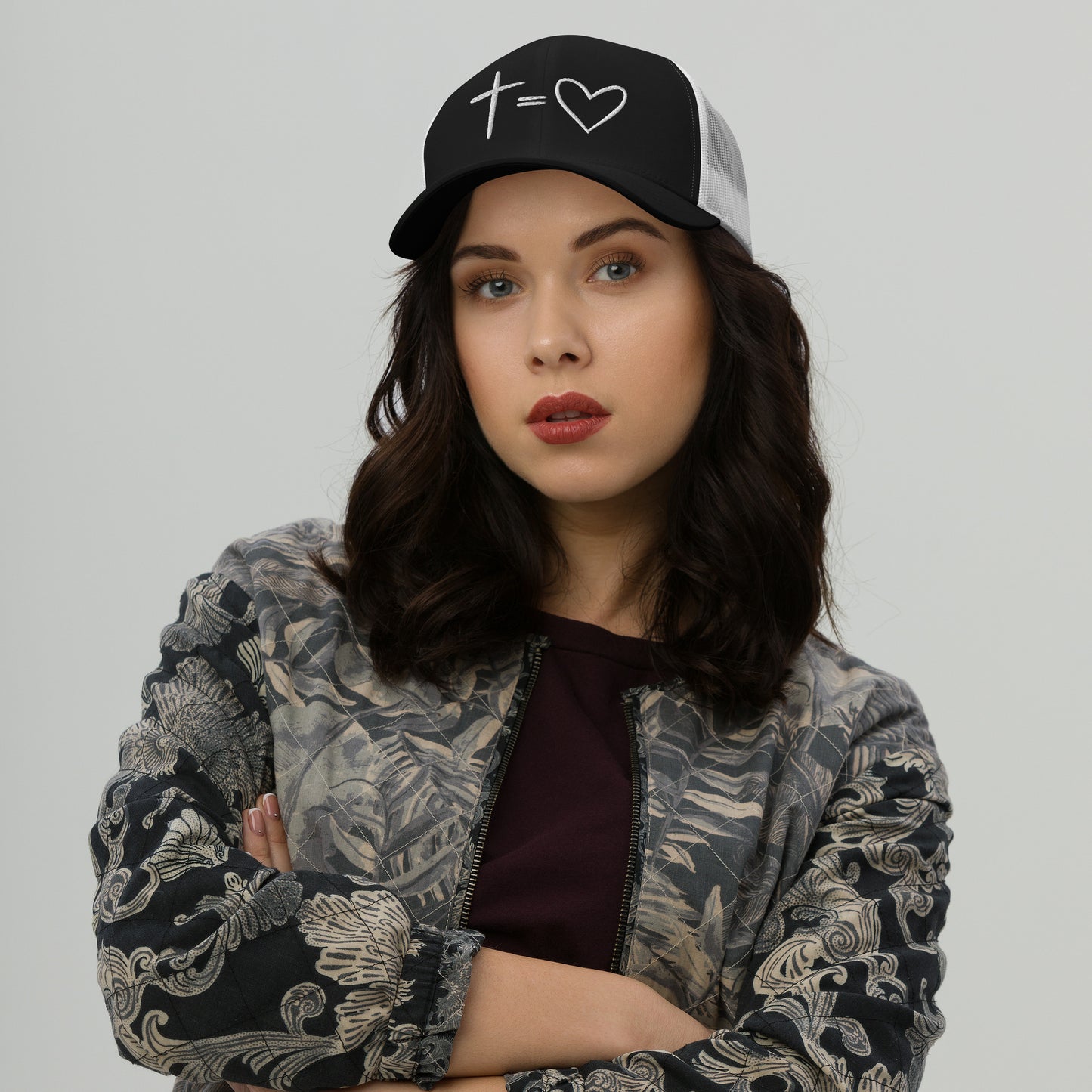 Model wearing charcoal and white Cross Equals Heart Christian trucker hat with mesh back