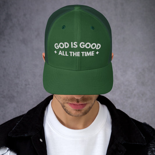 Man wearing green Christian GOD IS GOOD Trucker Hat with curved bill and white embroidery