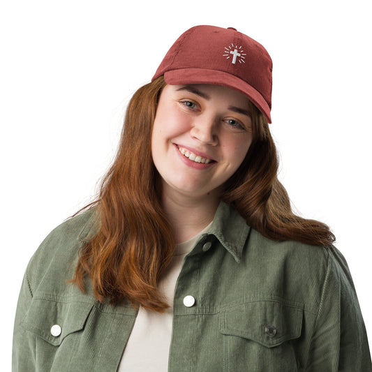 Woman wearing red Christian RADIANT CROSS Vintage Corduroy Hat with white embroidered cross and sun rays