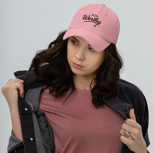 Front view of pink Christian WORTHY Dad Hat worn by female model