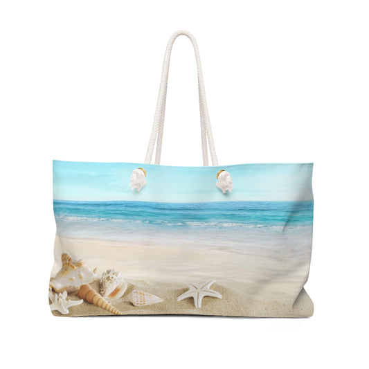 Oversized Seashell beach bag with delicate seashell pattern and rope handles, displayed upright.